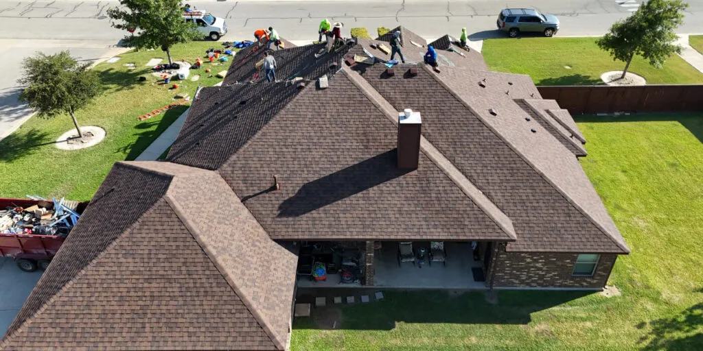 professionals performing a roof installation