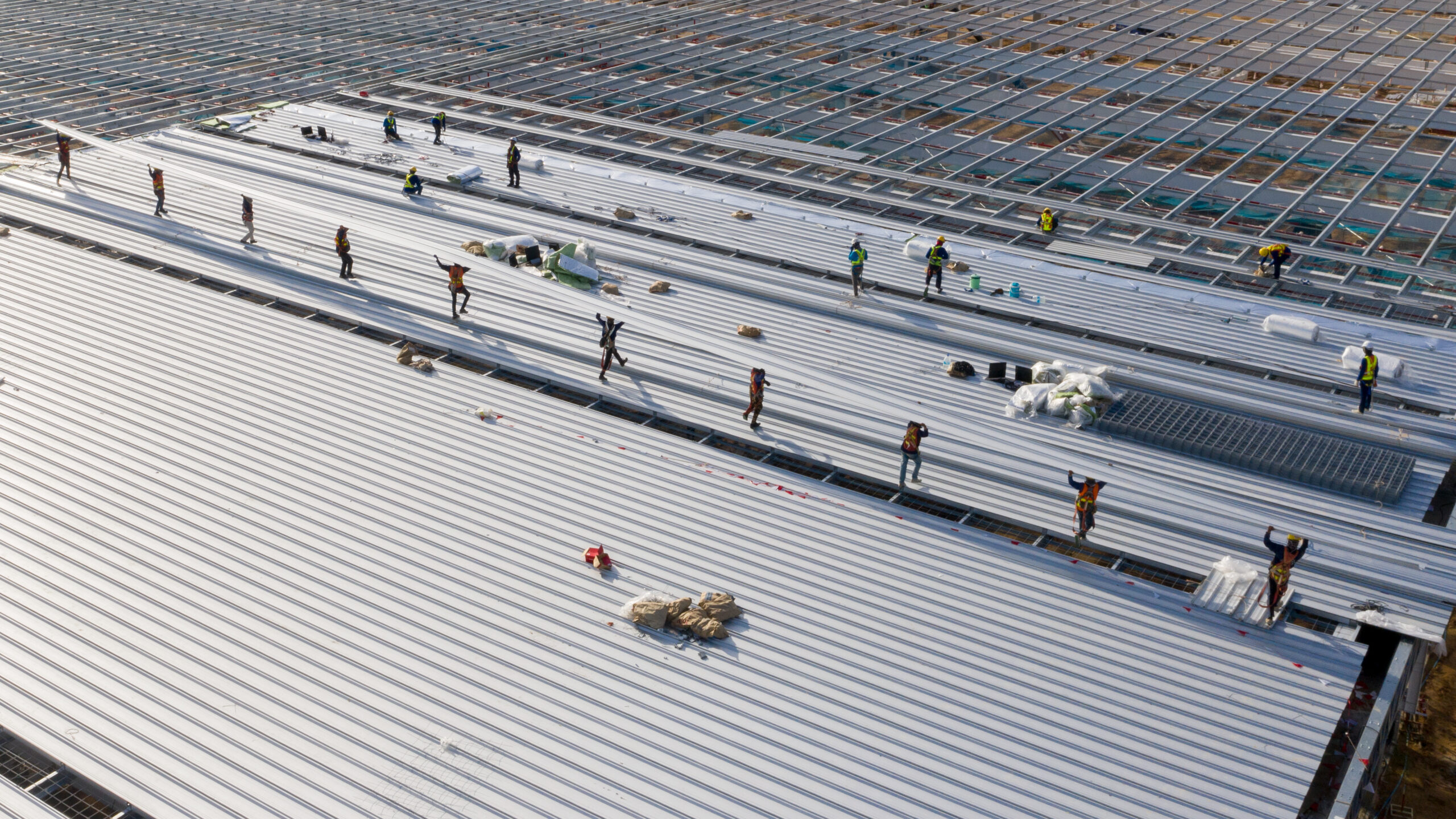 workers installing a commercial sheet metal roof
