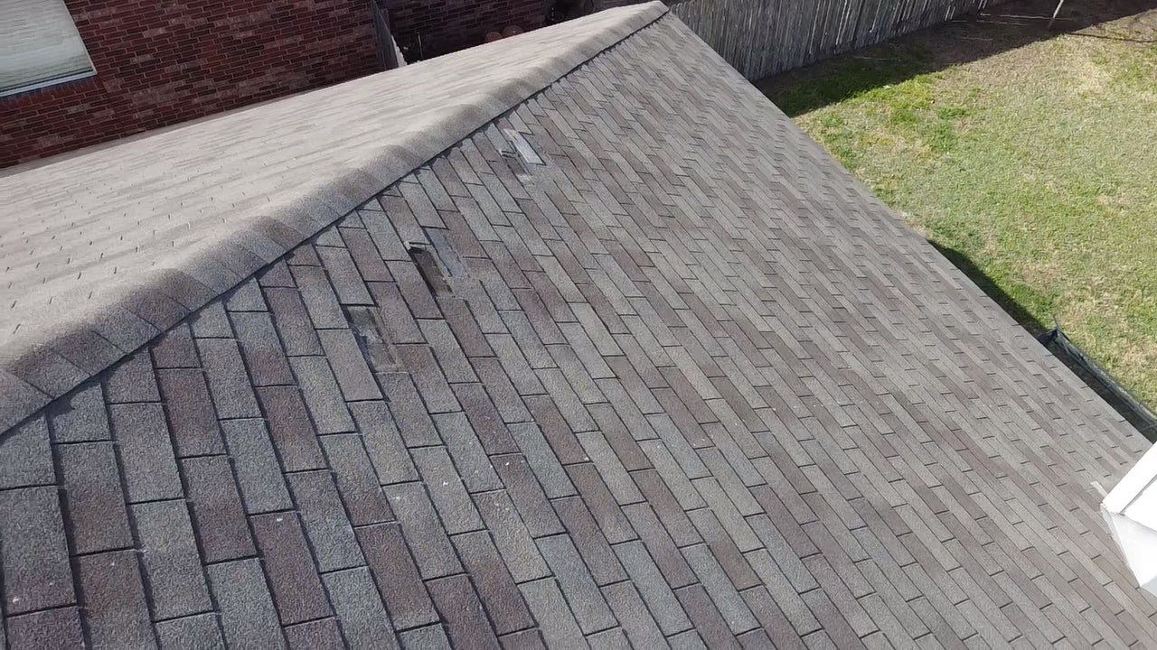 Wind damaged shingles in Buda